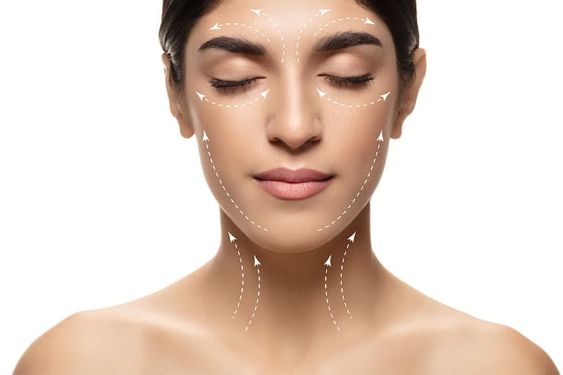 Woman showing facelift effects on her face
